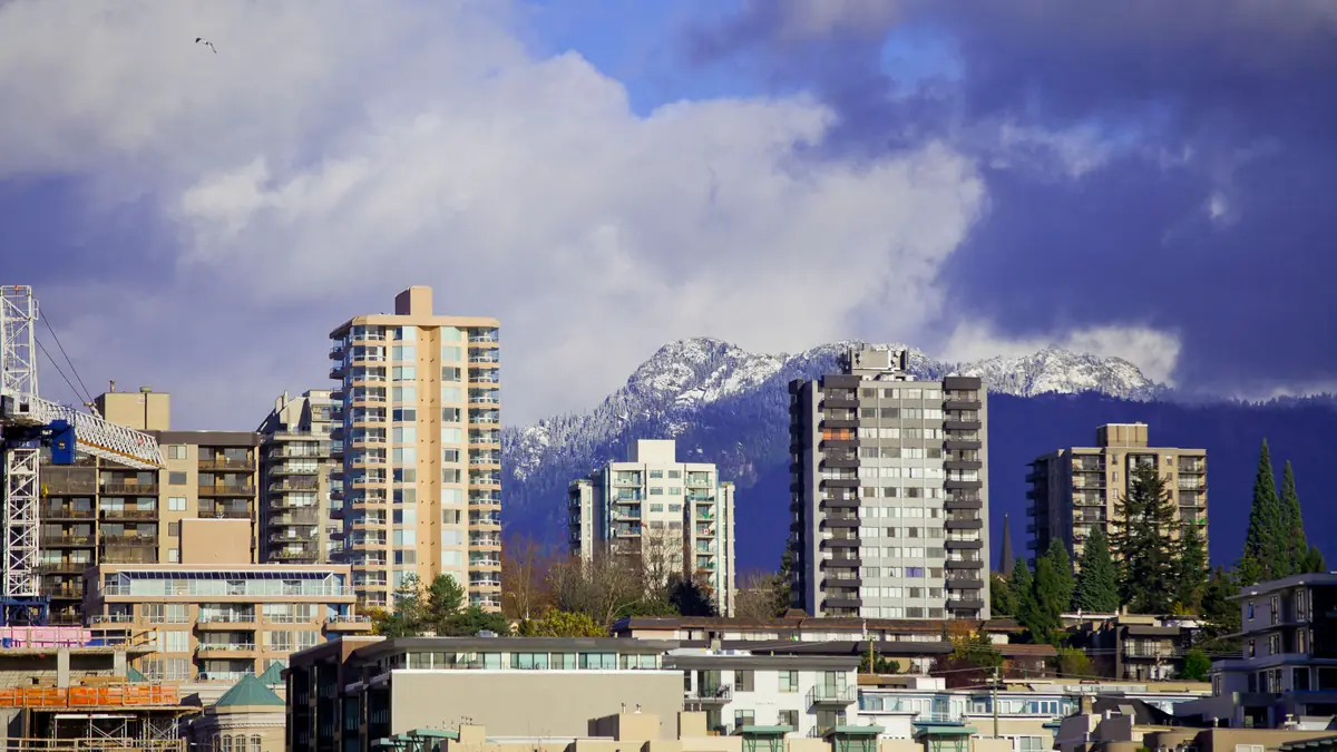Lower Lonsdale towers in North Vancouver with the snow-capped North Shore mountains behind