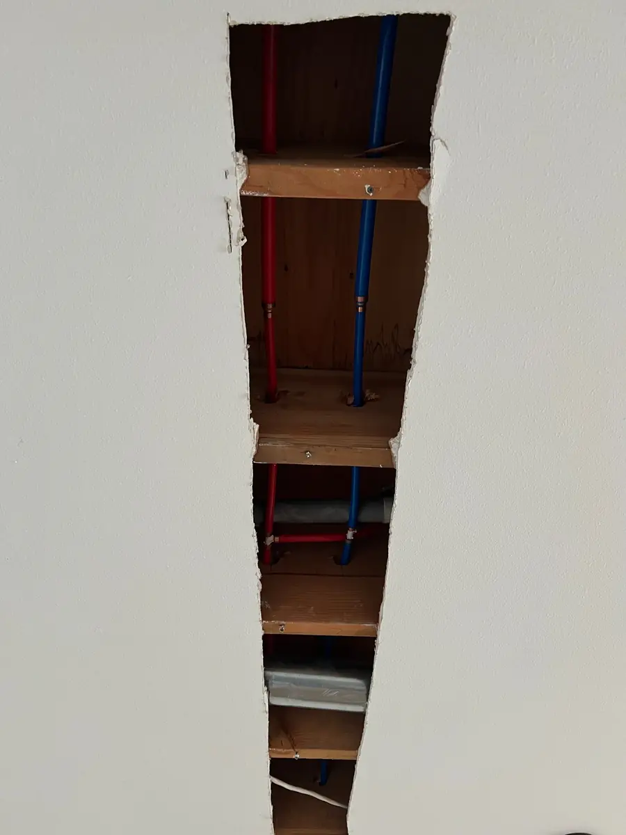Red and blue replacement water lines in the same ceiling section, Hollyburn, West Vancouver