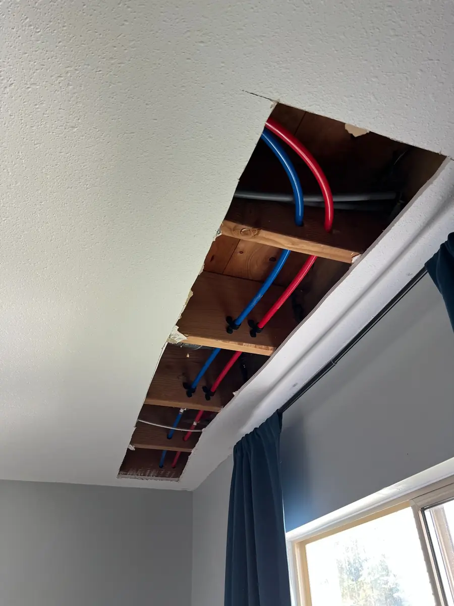 Replacement water lines routed through ceiling framing, Hollyburn, West Vancouver