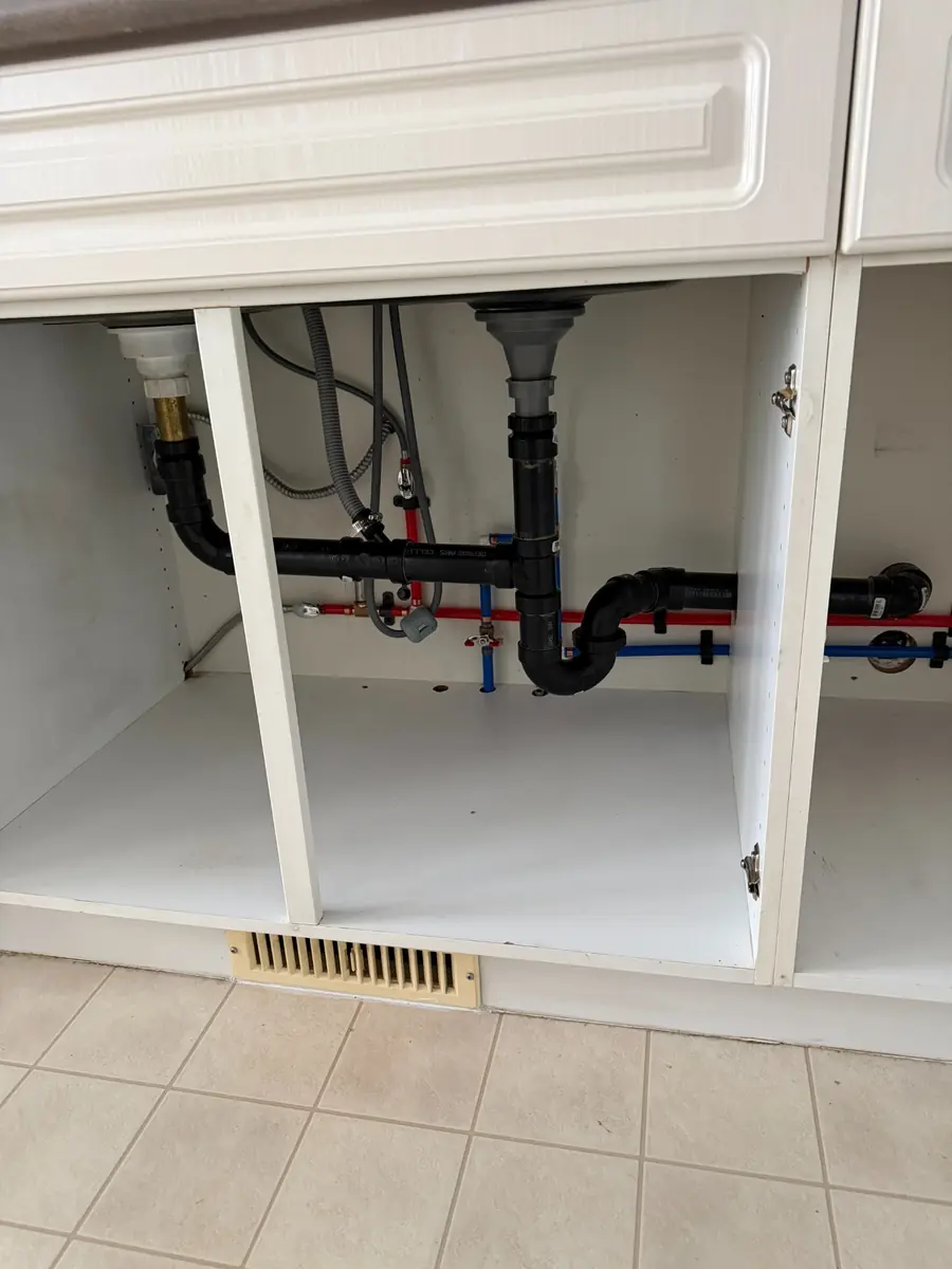 Under-sink water lines, shut-offs and drain connections after a repipe in Hollyburn, West Vancouver