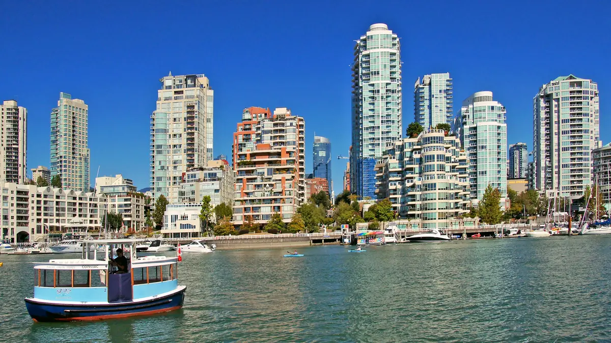 False Creek in Vancouver, with towers along the water and an Aquabus ferry